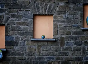 three globes against a wall, three globes against a wall,