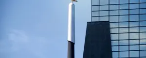 Seagull perched on a lamppost with Rotterdam Central Station's modern glass building in the background, Netherlands Seagull perched on a lamppost with Rotterdam Central Station's modern glass building in the background, Netherlands