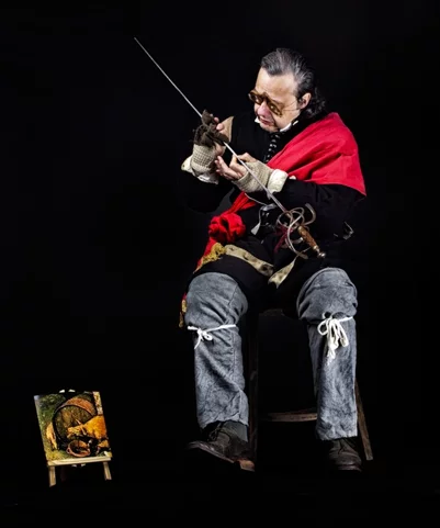  he polishes his sword whilst seated, a 17th-century soldier wearing spectacles,pictured in a photograph 