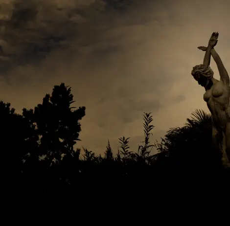 A statue photographed against the light in a bar in Gattinara, Italy
