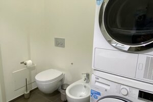 Bagno moderno con lavatrice e asciugatrice in appartamento premium a Cagliari