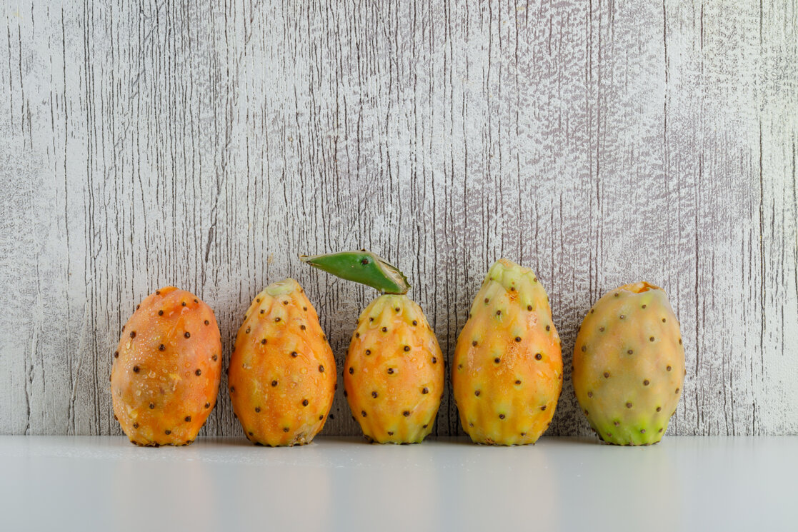 prickly-pears-side-view-white-grungy-grey-surface.jpeg