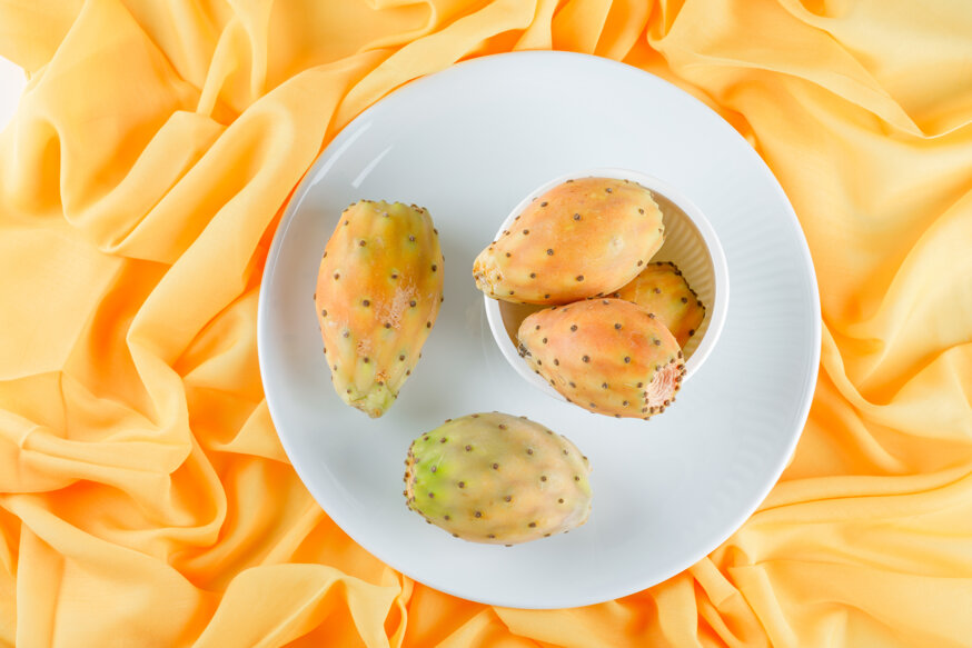 cactus-fruits-bowl-plate-yellow-textile-surface.jpeg