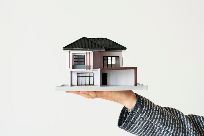 hand-presenting-model-house-for-home-loan-campaign.jpeg