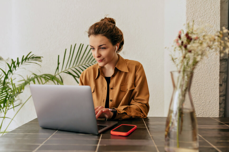 goodlooking-stylish-young-lady-with-collected-hair-and-nude-make-up-wearing-shirt-typing-on-laptop-in-cafe-concept-of-use-and-working-remote.jpeg