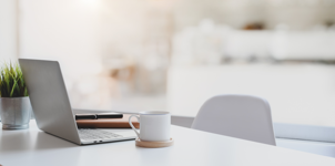 modern-workplace-with-laptop-computer-coffee-cup-office-supplies