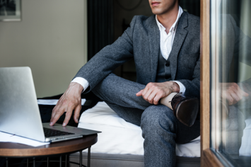 cropped-image-businessman-sitting-bed