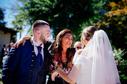 Celebrazione di un matrimonio con sposi sorridenti e invitata all'aperto in Piemonte