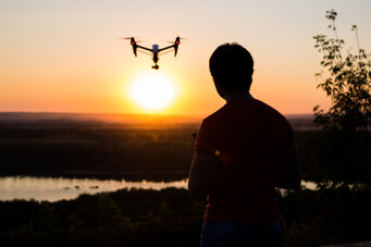 person-flying-drone-at-sunset-over-landscape-2026-01-09-06-21-49-utc.jpeg