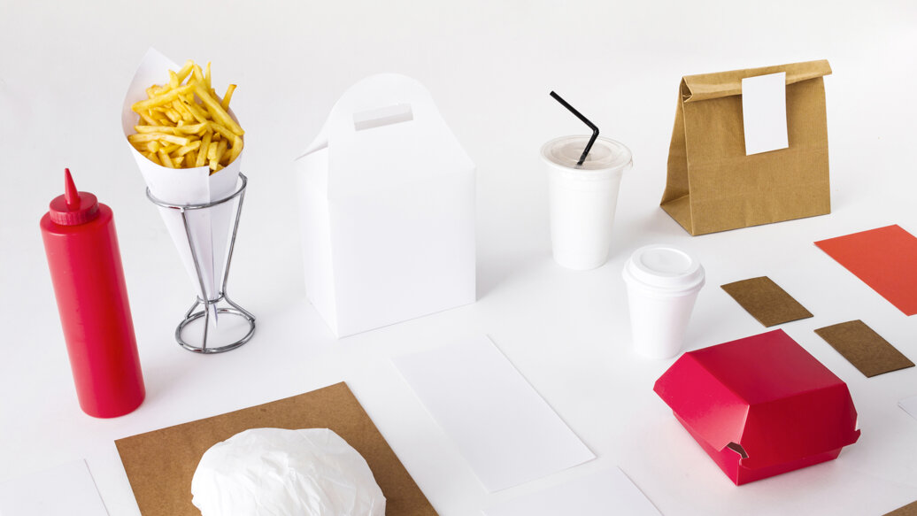 french-fries-with-packed-food-sauce-bottle-disposal-cup-white-backdrop.jpeg