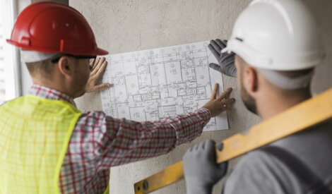 portrait-two-successful-architects-foreman-discussing-design-project.jpeg