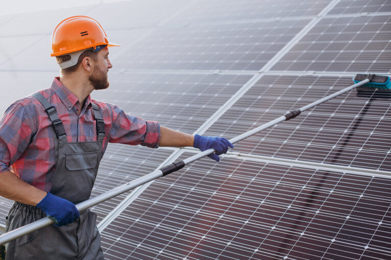 male-worker-cleaning-solar-panels.jpeg