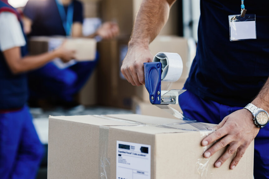 closeup-delivery-man-closing-carboard-box-with-tape-while-preparing-packages-shipment.jpeg closeup-delivery-man-closing-carboard-box-with-tape-while-preparing-packages-shipment.jpeg