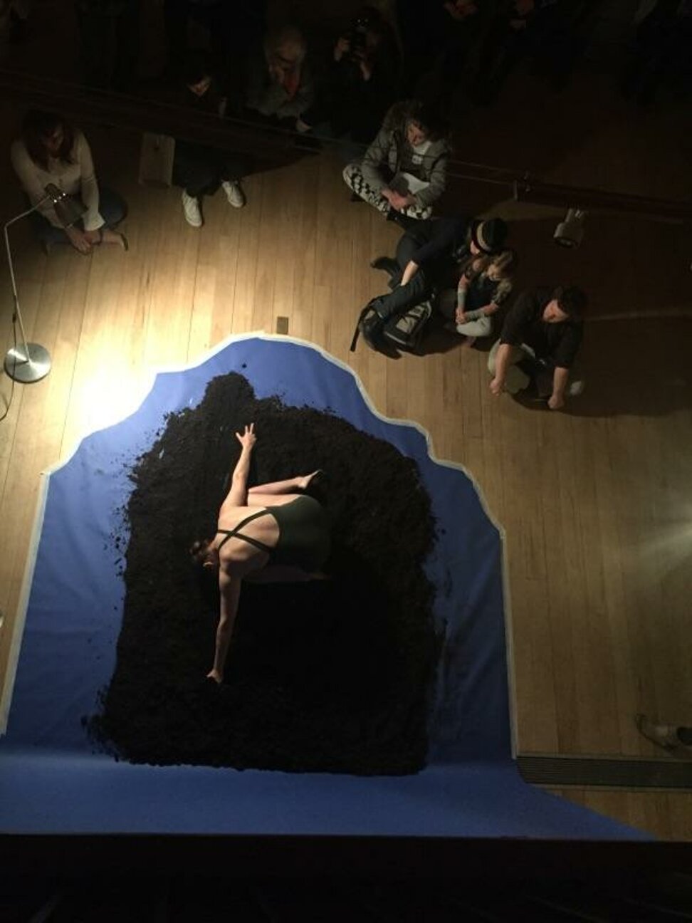Performer seen from above during a staged contemporary dance scene Performer seen from above during a staged contemporary dance scene