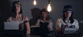 Theatrical performance scene with three performers and typewriters