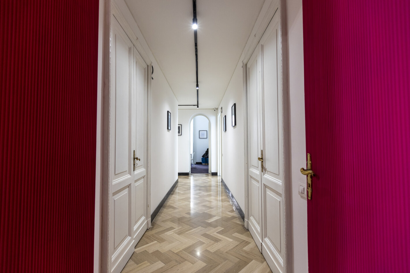 Corridor with red walls and white doors