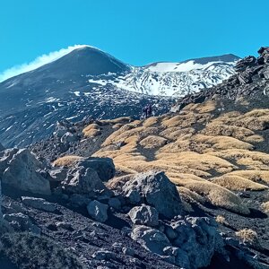 Etna trekking tour: view of the smoking summit craters from the ridges of Valle del Bove.