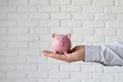 close-up-hand-holding-piggy-bank_23-2149191357.jpeg