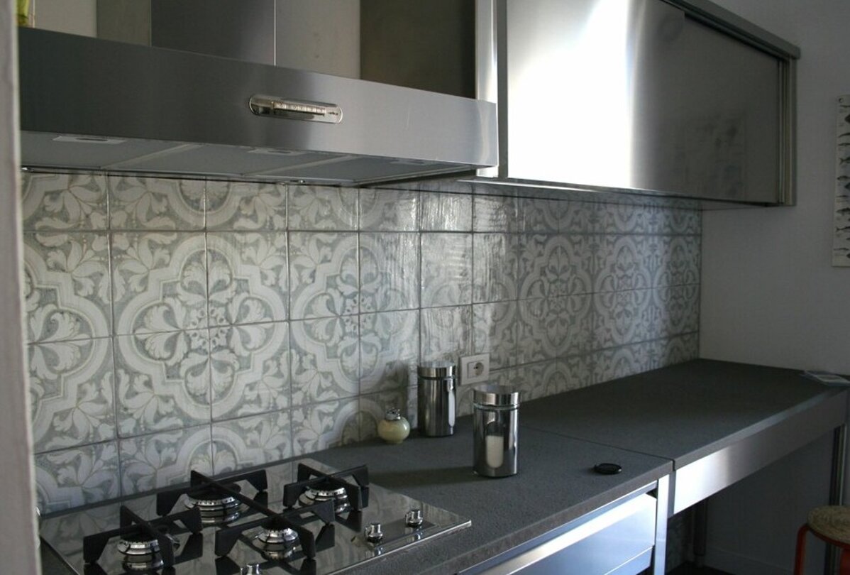 Contemporary kitchen with Sicilian tile backsplash and stainless steel appliances