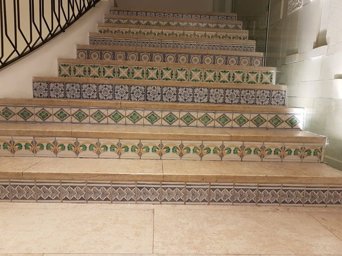 Stairs decorated with handcrafted Sicilian tiles featuring Mediterranean designs.