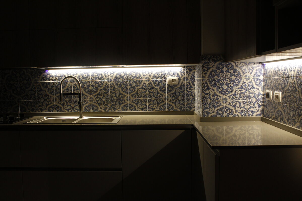Modern kitchen with Sicilian tiles backsplash and stainless steel sink
