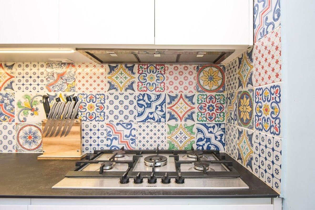 Kitchen backsplash with colorful Sicilian tiles.