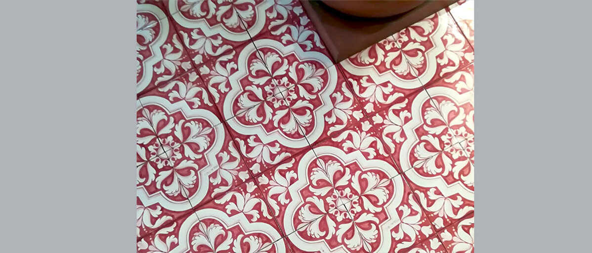 Red and white Sicilian tiles with intricate floral patterns, handcrafted ceramics, Mediterranean design.