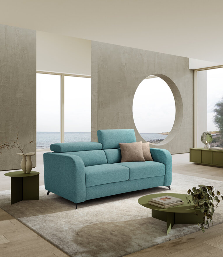 Modern living room with teal artisan sofa bed, ocean view, and contemporary decor