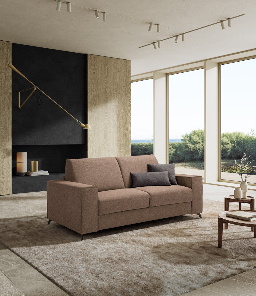 Divano letto artigianale marrone in soggiorno elegante con ampie finestre