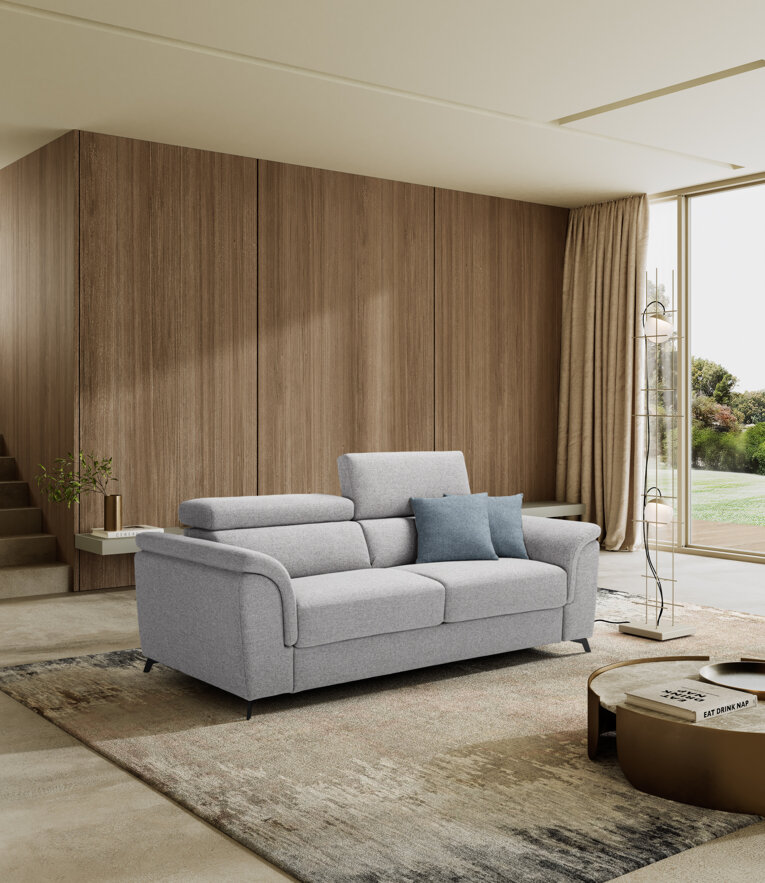 Modern gray sofa bed in a stylish living room with large windows