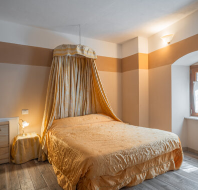 Cozy bedroom with canopy bed at Honey Apartment for a comfortable stay. Cozy bedroom with canopy bed at Honey Apartment for a comfortable stay.