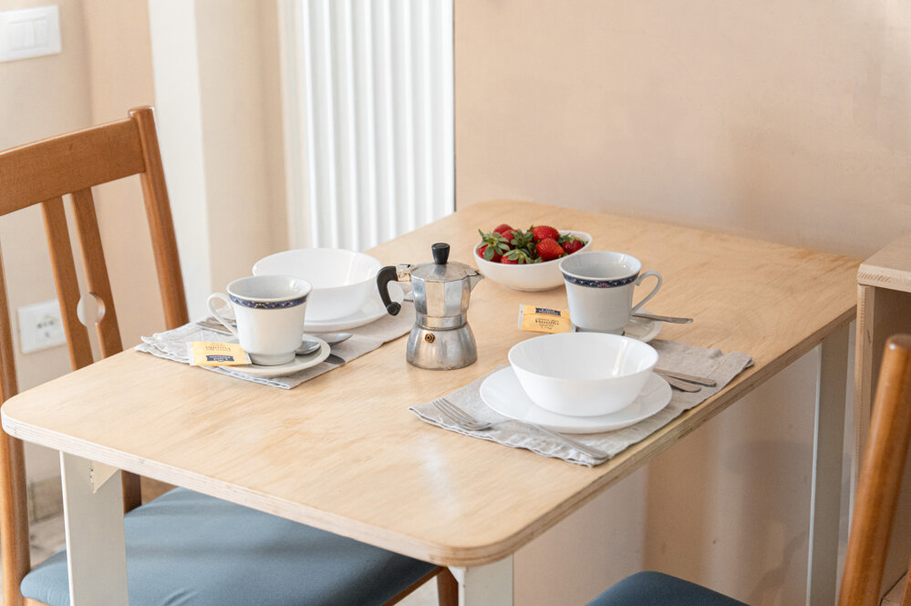 Cozy breakfast setup in Honey Apartment with coffee and strawberries Cozy breakfast setup in Honey Apartment with coffee and strawberries