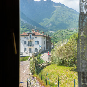 Vista dalla finestra su paesaggio montano con case e strada Vista dalla finestra su paesaggio montano con case e strada