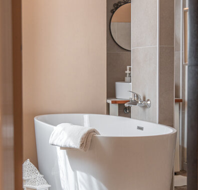 Elegant bathroom with a modern freestanding bathtub in a cozy accommodation Elegant bathroom with a modern freestanding bathtub in a cozy accommodation