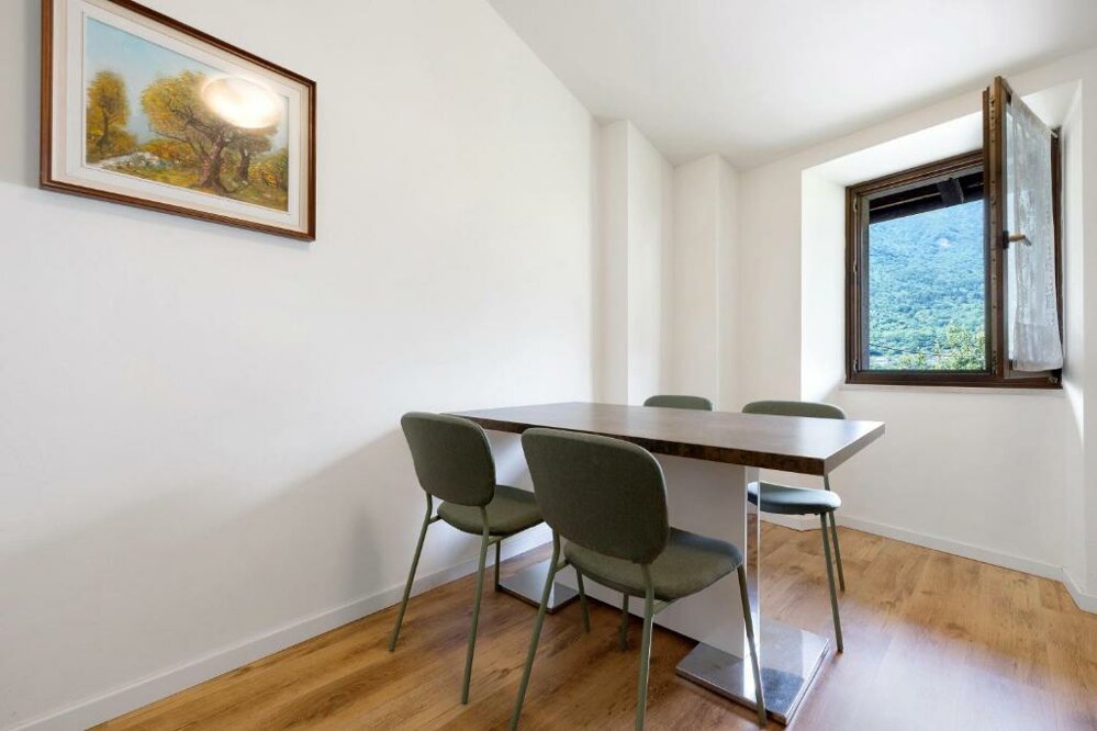 Spacious dining area in yellow apartment with modern furnishings Spacious dining area in yellow apartment with modern furnishings