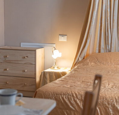 Cozy bedroom with warm lighting and wooden dresser, Honey Apartment Cozy bedroom with warm lighting and wooden dresser, Honey Apartment