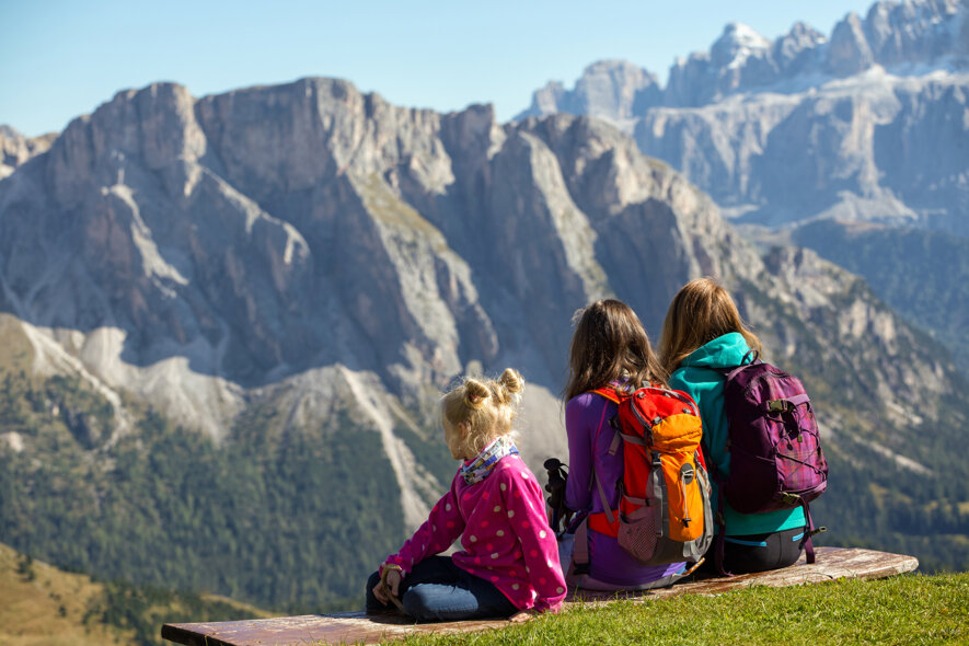 family-mother-two-sisters-girls-hikers-sitting-bench-mountains-dolomites-italy-seceda.jpeg