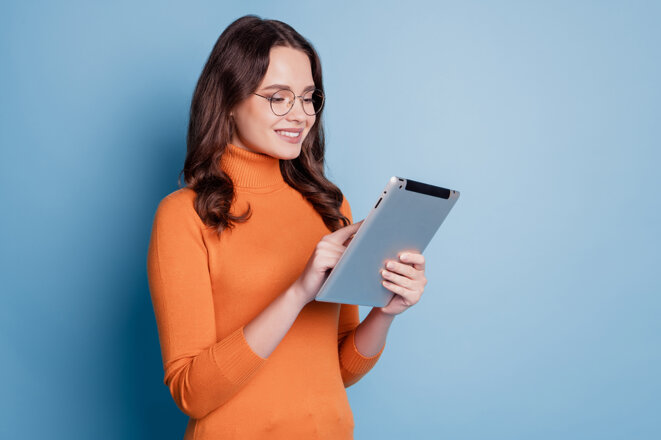profile-photo-happy-business-lady-hold-ebook-look-screen-read-study-posing-blue-background.jpeg