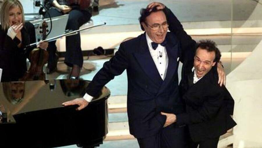 Sesso con minori: in difesa di don Rugolo la foto di Baudo e Benigni