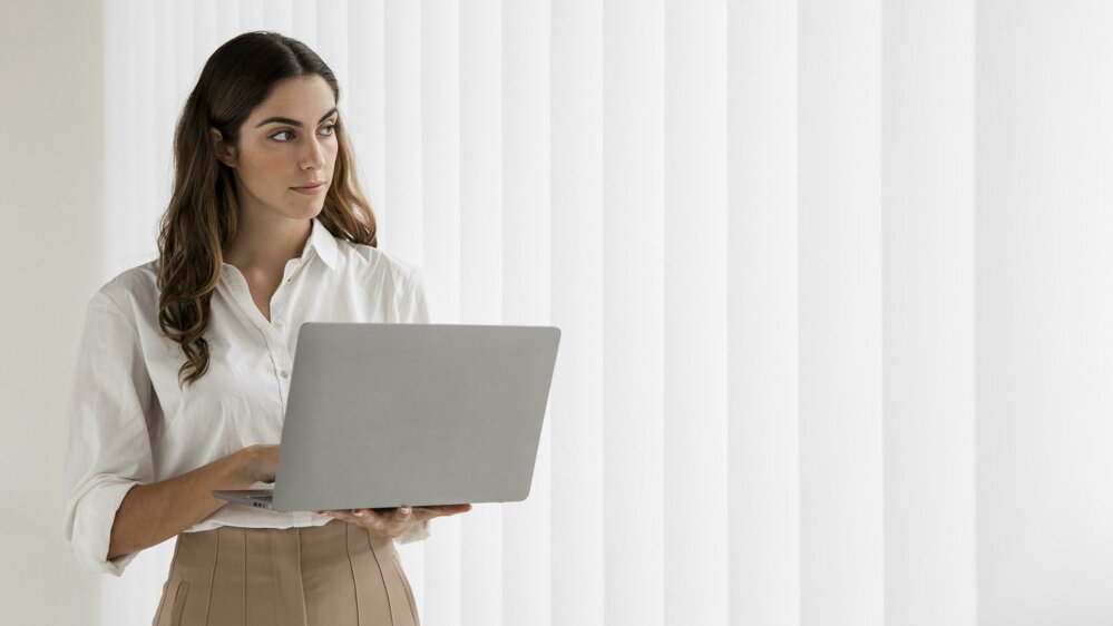 front-view-elegant-businesswoman-using-laptop-with-copy-space.jpeg