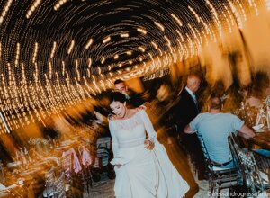 Bride dancing under twinkling lights at a Sicily wedding