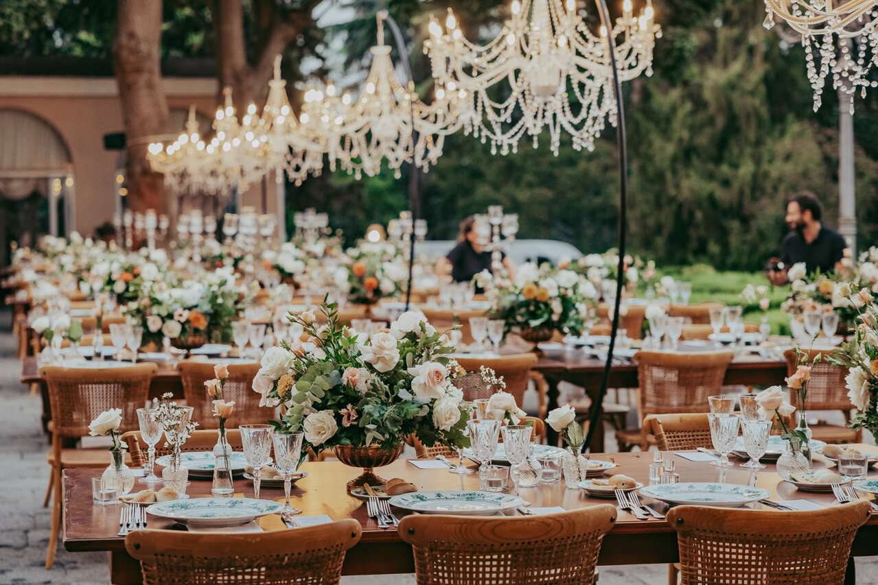 Elegant Sicilian wedding setup with floral decorations and chandeliers