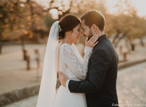 Bride and groom embracing at sunset in Sicily.