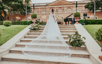 Bride on elegant staircase at luxury Sicilian wedding venue