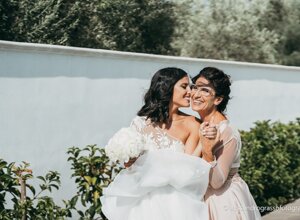 Bride hugging woman in garden at Sicily wedding