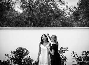 Bride getting ready with makeup artist outdoors