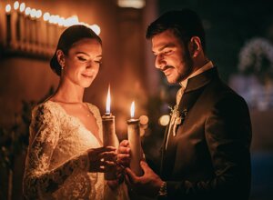 Bride and groom holding candles during an intimate wedding ceremony