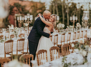 Couple embracing at an elegant outdoor wedding reception