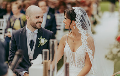 Bride and groom smiling during outdoor wedding ceremony in Sicily