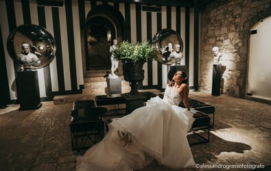 Bride in luxurious setting with statues, luxury Sicilian wedding ambiance